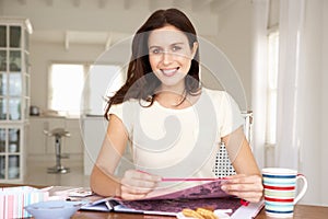 Woman scrapbooking at table