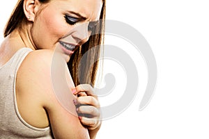 Woman scratching her arm