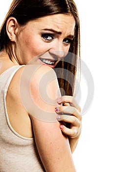 Woman scratching her arm