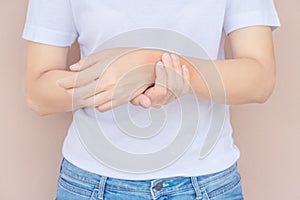 Woman scratching her elbow.