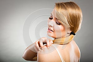 Woman scratching her itchy arm with allergy rash