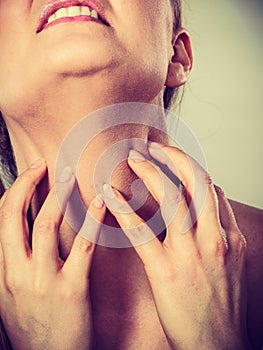 Woman scratching her itchy neck with allergy rash