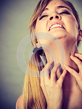 Woman scratching her itchy neck with allergy rash