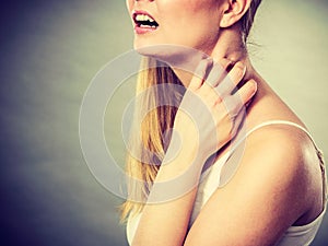 Woman scratching her itchy neck with allergy rash