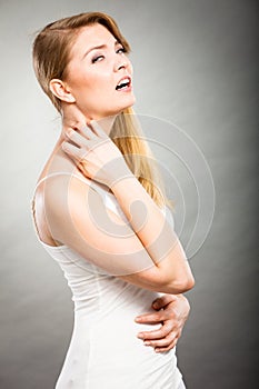 Woman scratching her itchy neck with allergy rash