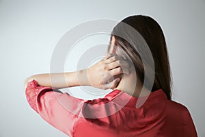 Woman scratching her neck