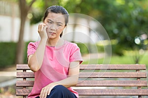 Woman scratching her skin at park garden