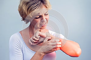 Woman Scratching an itch on white background . Sensitive Skin, F photo