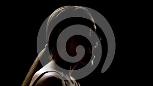 Woman screaming against black background, relieving stress, psychotherapy photo