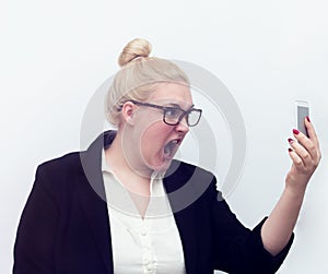 Woman screaming at cell phone on white