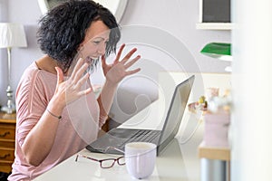 Woman screaming in front of her computer