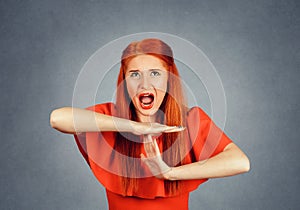 Woman screaming looking up with rage expression showing time out with hands