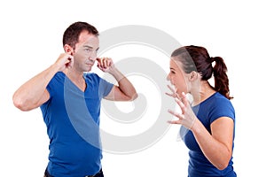 Woman screaming with a man, him with hands on ears