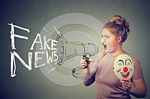 Woman screaming in a megaphone spreading fake news