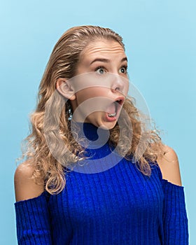 The woman screaming with open mouth isolated on blue background, concept face emotion
