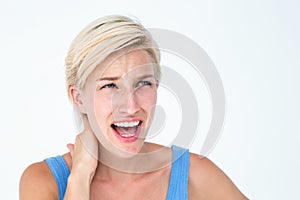 Woman screaming and suffering from neck pain