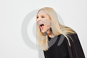 Woman screams in irritation leaning forward