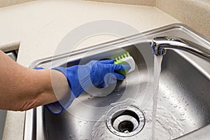 Woman Scrubbing Sink photo