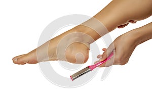 Woman scrubing her feet with a grater