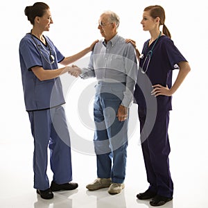 Woman in scrubs shaking hands