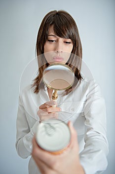 Woman scrutinizing nutrition label