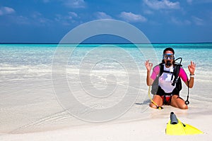 Woman in scuba diving gear on a beach