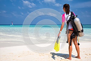 Woman in scuba diving gear on a beach