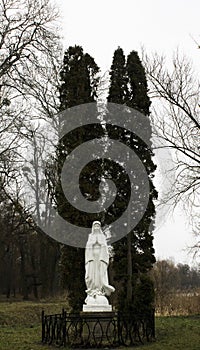 Woman sculpture in the park. Beautiful nature. Autumn