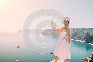 Woman sea laptop. Business woman in yellow hat freelancer with laptop working over blue sea beach. Girl relieves stress