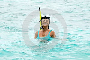 Woman in the sea during snorkeling in blue water