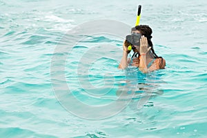 Woman in the sea during snorkeling in blue water