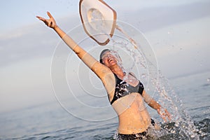 Woman in sea water with splashes.