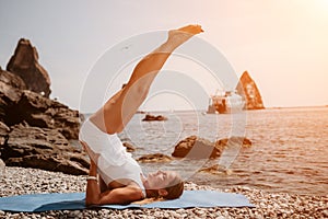 Woman sea yoga. Two happy women practicing yoga on the beach with ocean and rock mountains. Motivation and inspirational