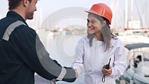 Woman seafarer shaking hand of port control inspector