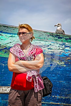 Woman and seagull in a port