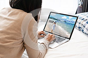 Woman search ticket reservation for holiday. Girl using travel application for flight tickets and hotel room online booking.