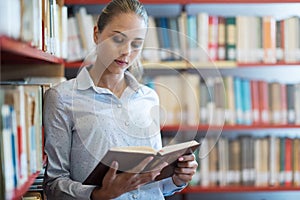Woman searching books at the library