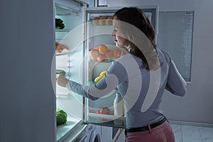 Woman Searching For Food In The Fridge