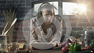 Woman searching recipes on her digital tablet