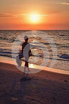 Woman on the seashore in a beautiful evening scenery.