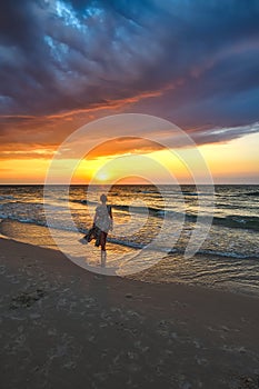 Woman on the seashore in a beautiful evening scenery.