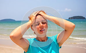 Woman by seaside with sunstroke. Health problem on vacation. Medicine on vacation.