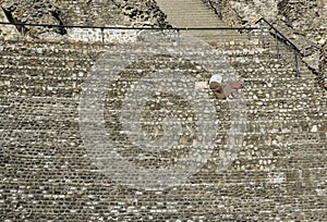 Woman seated alone at the Amphitheater of the Three Gauls in Lyon, France