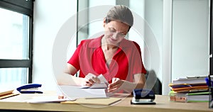 Woman secretary looking for right document in stack of papers 4k movie slow motion