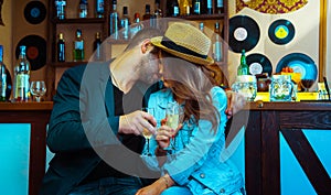 Woman seducing a man in a bar and drinking champagne