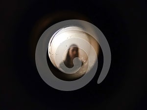 Woman seen through the peephole