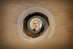 Woman seen through the peephole