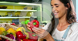 Woman selecting bell peppers in organic section