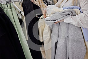 Woman selecting clothes in shop.Close up of hangers row.