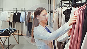 Woman Selecting a Dress at Boutique